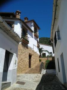 a building with stairs leading up to a house at Casa Rural Aya I in Linares de la Sierra