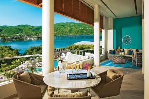 a dining room with a view of the water at Breathless Montego Bay in Montego Bay