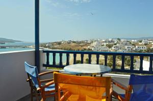 a table and chairs on a balcony with a view at Atlantida Hotel in Koufonisia