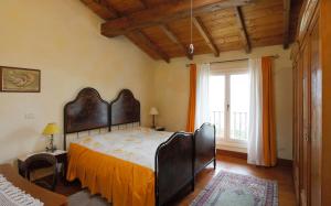 a bedroom with a large bed with an orange sheet at Belvedere in Zola Predosa