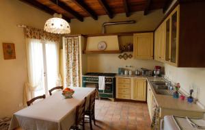 a kitchen with a table and a kitchen with a stove at Belvedere in Zola Predosa