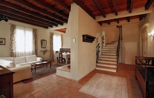 a living room with a white couch and a staircase at Belvedere in Zola Predosa