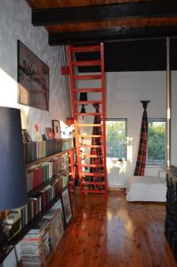 a living room with a red ladder and bookshelves at Чудо-Дом для Чудо-Людей in Plakhtyanka
