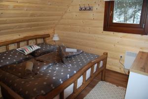 A bed or beds in a room at Chata Nezábudka