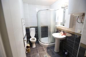 a bathroom with a shower and a toilet and a sink at Nova Apartments in Ohrid +40 photos