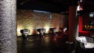 a room with a brick wall with four sinks in it at Suites at Mayan Palace Vidanta Resort Riviera Maya in Playa del Carmen