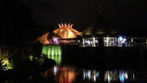 a building lit up at night next to a body of water at Suites at Mayan Palace Vidanta Resort Riviera Maya in Playa del Carmen