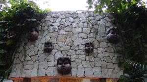 a stone wall with a bunch of faces on it at Suites at Mayan Palace Vidanta Resort Riviera Maya in Playa del Carmen