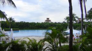 a view of a pool at a resort with palm trees at Suites at Mayan Palace Vidanta Resort Riviera Maya in Playa del Carmen