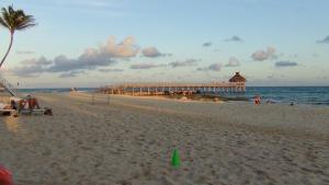a sandy beach with a pier in the ocean at Suites at Mayan Palace Vidanta Resort Riviera Maya in Playa del Carmen