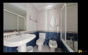 a bathroom with a white sink and a toilet at Hostal Alba in La Mata +186 photos