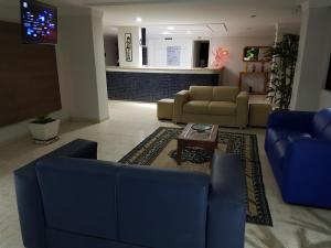 a living room with blue couches and a table at Victory Flat Intermares n 64 ap 406 - Avenida Oceano Índico 64 -Intermares Cabedelo PB in Cabedelo