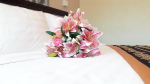 A bed or beds in a room at Grand Laurel Hotel