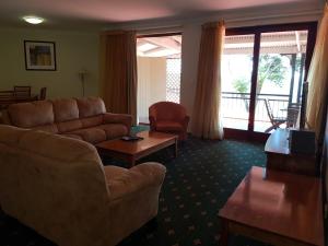 a living room with a couch and a table at Mayfield on Montville in Montville