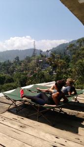 a group of people laying on a hammock on a table at Ella Rawana Den Hotel in Ella