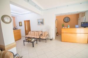 a waiting room with a couch and a table at Rooms Nancy in Agios Andreas