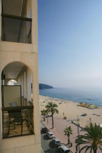 
a beach with a balcony overlooking the ocean at Apartaments Rosanna in Lloret de Mar
