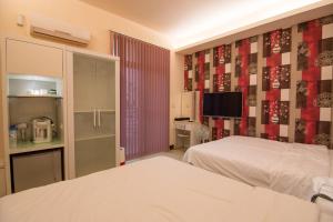 Rúm í herbergi á Days Good Guest House