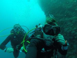 a person taking a picture of a diver in the water at Il Paradiso Sul Mare in Siracusa +34 photos