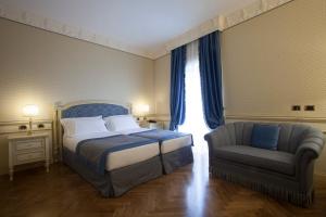 Säng eller sängar i ett rum på Hotel Marconi