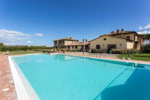 a large swimming pool in front of a house at Principe Del Trasimeno in Castiglione del Lago