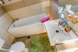 a bathroom with a tub and a toilet and a sink at Nina in Herceg-Novi +30 photos