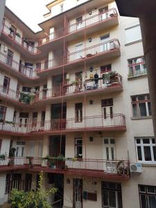 an apartment building with balconies and plants on it at Valentina Guesthouse in Budapest