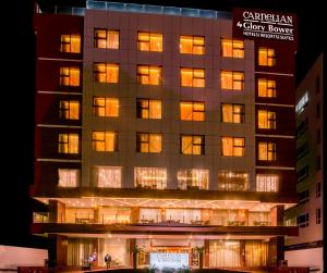 a rendering of the exterior of a hotel at night at Carnelian by Glory Bower Hotels in Muscat