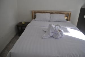 A bed or beds in a room at Budidin Homestay