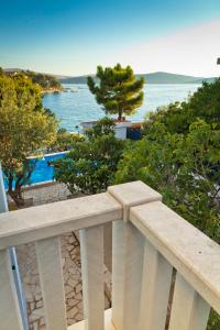 a white balcony with a view of the ocean at Delux Villa Hedonica in Zaboric