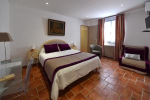 een slaapkamer met een bed, een stoel en een raam bij Domaine De Foresta in Bonifacio +30 foto's