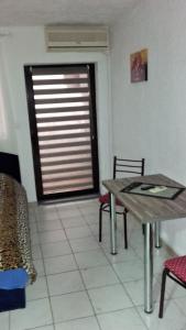 a dining room with a table and a window at Apartments Petrovic in Krimovice