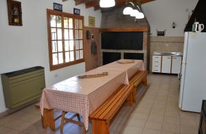 a kitchen with a table and a refrigerator at Patagonia Apart in Esquel