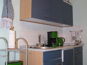 a kitchen with a sink and a counter top at Cozy Apartment in Boltenhagen near Seabeach in Boltenhagen