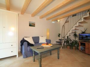 a living room with a couch and a table with a bowl of fruit at Modern Holiday Home in Steffenshagen with Terrace in Steffenshagen