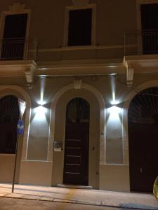 a building with a black door with lights on it at L'arco di porta Lecce in Brindisi