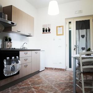 a kitchen with a sink and a counter top at B&B Casa Dolce Casa Monopoli in Monopoli