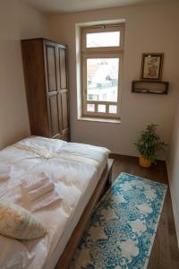 a bedroom with a bed and a window and a rug at Apartments Salim in Sarajevo