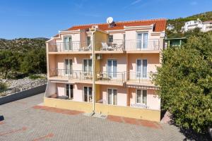 a large building with a balcony on the side of it at Apartments Neve in Marina