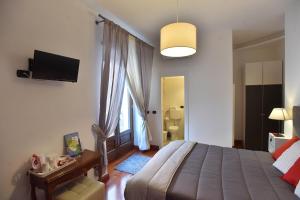 a bedroom with a bed and a tv on the wall at Residenza D'Epoca B&B Celeste in Caserta