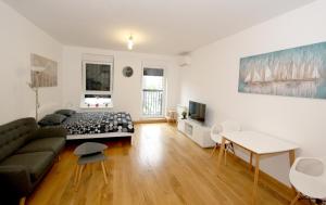 a living room with a couch and a table at Apartment Moonstone in Belgrade