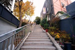 a staircase leading up to a building with flowers at Family Hotel BNB in Busan