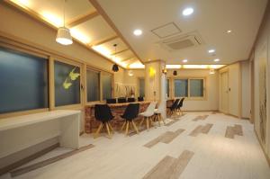 a living room with a table and chairs at Family Hotel BNB in Busan