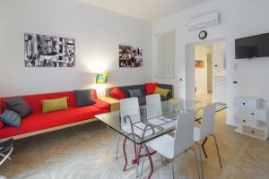 ナポリにあるSpaccanapoli Home Short Letsのリビングルーム(赤いソファ、ガラステーブル付)