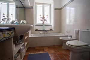 a bathroom with a tub and a toilet and a sink at Rosa Dei Venti in Lipari
