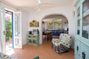 a living room with a chair and a table at Rosa Dei Venti in Lipari