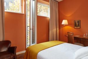 Postel nebo postele na pokoji v ubytování hotel brasserie au violon