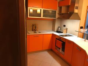 a kitchen with orange cabinets and a sink at Fantastic 3 bedroom Apartment in Sofia