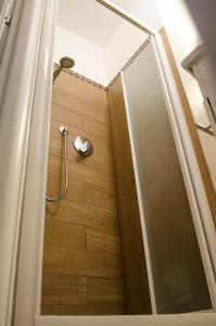 a shower with a glass door in a bathroom at Medieval central apartment in Bologna