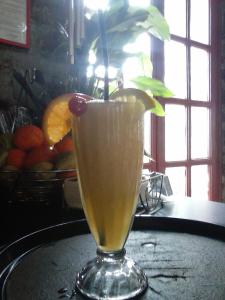 a drink in a glass sitting on a table at Ξενώνας questhouse Electra isari in Isaris +83 photos